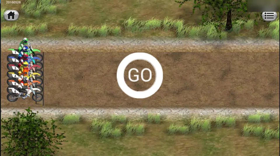 Dirt Bike start line with six riders lined up on the left of a dirt track and a GO sign in the middle